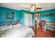 Bedroom features blue walls, hardwood floors, a ceiling fan, and view to the hallway and kitchen at 50 Crestview Dr, Greenwood, IN 46143
