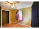 A bright bedroom with laminate flooring, a ceiling fan, and a closet at 50 Crestview Dr, Greenwood, IN 46143