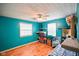 A bright bedroom with turquoise walls, and laminate flooring at 50 Crestview Dr, Greenwood, IN 46143