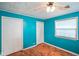 A simple bedroom with turquoise walls and laminate flooring at 50 Crestview Dr, Greenwood, IN 46143