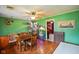 Bright dining room with hardwood floors, ample seating, and plant decor at 50 Crestview Dr, Greenwood, IN 46143