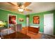 Dining room with wood floors, a ceiling fan, and an open view to the kitchen at 50 Crestview Dr, Greenwood, IN 46143