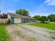 Blue single story home with a gravel driveway and a charming fenced yard at 50 Crestview Dr, Greenwood, IN 46143