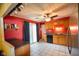 This kitchen has red walls, light wood cabinets, gray countertops, tile floors, and sliding glass doors at 50 Crestview Dr, Greenwood, IN 46143