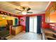 Eat-in kitchen features a ceiling fan, gray countertops, red walls, tile floors, and sliding glass doors at 50 Crestview Dr, Greenwood, IN 46143