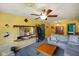 Living room featuring yellow walls, neutral carpet, and views to the dining room and front door at 50 Crestview Dr, Greenwood, IN 46143
