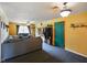 Open living room features yellow walls, neutral carpet, and a view to the green front door at 50 Crestview Dr, Greenwood, IN 46143