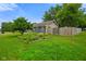 View of the side yard with established garden beds and wood fence at 50 Crestview Dr, Greenwood, IN 46143