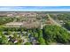 Expansive aerial view showcases the neighborhood, commercial area, and surrounding greenery at 5010 Donner Ln, Indianapolis, IN 46268