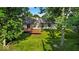 Backyard view showing mature trees, a well-manicured lawn, and a spacious deck at 5010 Donner Ln, Indianapolis, IN 46268
