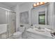 Well-lit bathroom featuring a glass enclosed shower and vanity with plenty of counterspace at 5010 Donner Ln, Indianapolis, IN 46268