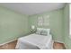 Light-filled bedroom with pleasing green walls and a comfortable bed setting at 5010 Donner Ln, Indianapolis, IN 46268