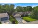 Inviting single-story home with lush green lawn and mature trees for added curb appeal at 5010 Donner Ln, Indianapolis, IN 46268