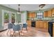 Open kitchen boasts modern appliances, wood cabinets, hardwood floors and lots of natural light at 5010 Donner Ln, Indianapolis, IN 46268