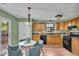 Bright kitchen features wooden cabinets, modern appliances, and adjacent breakfast nook with deck access at 5010 Donner Ln, Indianapolis, IN 46268