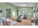 Comfortable living room with a fireplace, neutral tones, and views into other living areas at 5010 Donner Ln, Indianapolis, IN 46268