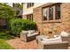 Backyard patio with comfortable seating, mature trees, and brick detailing at 5615 N Pennsylvania St, Indianapolis, IN 46220