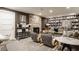 Finished basement with stone fireplace, built-in bookshelves, and comfortable seating at 5615 N Pennsylvania St, Indianapolis, IN 46220