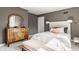 Lovely bedroom featuring antique wooden dresser, neutral walls, carpet, and nice natural light at 5615 N Pennsylvania St, Indianapolis, IN 46220