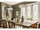 Dining room showcasing a large dining table with decorative vases, chairs, and a large painting at 5615 N Pennsylvania St, Indianapolis, IN 46220