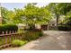 Long driveway leading to a two car garage, surrounded by mature trees at 5615 N Pennsylvania St, Indianapolis, IN 46220