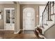 Inviting entryway features hardwood floors, stairs, built-in cabinet, and a decorative front door at 5615 N Pennsylvania St, Indianapolis, IN 46220