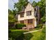 Charming Tudor-style home with well-manicured lawn and inviting outdoor seating area at 5615 N Pennsylvania St, Indianapolis, IN 46220