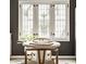 Kitchen breakfast area with a round table, seating for two, and an adjacent window at 5615 N Pennsylvania St, Indianapolis, IN 46220