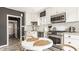 Bright kitchen features white cabinets, stainless steel appliances, and herringbone backsplash at 5615 N Pennsylvania St, Indianapolis, IN 46220
