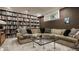 Cozy living room with a large bookcase, comfortable seating, and a decorative stained glass window at 5615 N Pennsylvania St, Indianapolis, IN 46220