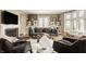 Bright living room with hardwood floors, fireplace, large windows, and stylish contemporary furnishings at 5615 N Pennsylvania St, Indianapolis, IN 46220