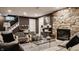 Inviting living room with stone fireplace, zebra print chairs, and a functional built-in desk area at 5615 N Pennsylvania St, Indianapolis, IN 46220