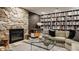 Stylish living room featuring a stone fireplace, built-in bookcase, and contemporary furniture at 5615 N Pennsylvania St, Indianapolis, IN 46220