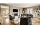 Bright living room with hardwood floors, fireplace, large windows, and stylish contemporary furnishings at 5615 N Pennsylvania St, Indianapolis, IN 46220