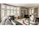 Inviting living room featuring a comfortable sofa, glass coffee table, and an abundance of natural light from large windows at 5615 N Pennsylvania St, Indianapolis, IN 46220