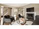 Bright living room featuring fireplace, hardwood floors, and stylish contemporary furnishings at 5615 N Pennsylvania St, Indianapolis, IN 46220