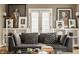 Bright living room with hardwood floors, fireplace, large windows, and stylish contemporary furnishings at 5615 N Pennsylvania St, Indianapolis, IN 46220