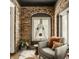 Charming sitting area with brick arch, comfortable chair, and an adjacent plant in a naturally lit space at 5615 N Pennsylvania St, Indianapolis, IN 46220
