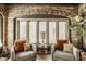 Cozy sitting area with comfortable chairs, a side table, and natural light from the window at 5615 N Pennsylvania St, Indianapolis, IN 46220