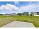 Large community backyard with green grass and a view of multiple neighborhood homes at 5763 Greenbrier Ct, Brownsburg, IN 46112