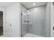 Modern bathroom features gray tiling and sleek glass enclosed shower at 5763 Greenbrier Ct, Brownsburg, IN 46112