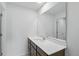 Modern bathroom features a long white countertop with brown cabinets, a large mirror, and tiled floors at 5763 Greenbrier Ct, Brownsburg, IN 46112