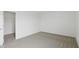 Bedroom featuring new carpet, white trim, and adjacent walk in closet at 5763 Greenbrier Ct, Brownsburg, IN 46112