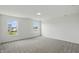 Spacious bedroom with neutral carpet and large windows showcasing the exterior view at 5763 Greenbrier Ct, Brownsburg, IN 46112
