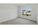 Bright bedroom with neutral carpet, large window offering natural light and a view to the neighborhood at 5763 Greenbrier Ct, Brownsburg, IN 46112