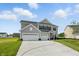 Charming home with a large driveway and green lawn on a sunny day surrounded by other homes at 5763 Greenbrier Ct, Brownsburg, IN 46112