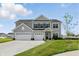 Beautiful two-story home featuring a three-car garage and well-manicured lawn in a suburban neighborhood at 5763 Greenbrier Ct, Brownsburg, IN 46112