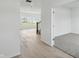 Open hallway leading to a carpeted bedroom and a view of the staircase and living area beyond at 5763 Greenbrier Ct, Brownsburg, IN 46112