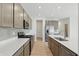 Modern kitchen featuring stainless appliances, gray cabinetry, tiled backsplash, and expansive counter space at 5763 Greenbrier Ct, Brownsburg, IN 46112