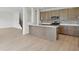 Modern kitchen with stainless steel appliances, a large island, and lots of cabinet storage space at 5763 Greenbrier Ct, Brownsburg, IN 46112